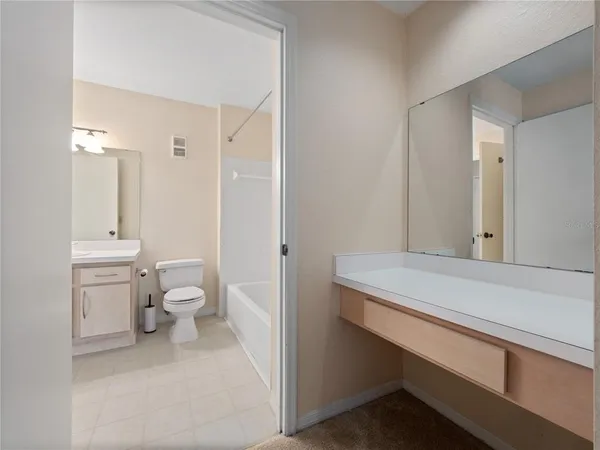 a bathroom with a sink a toilet and a shower