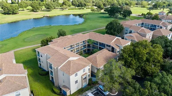 an aerial view of a house with yard swimming pool and outdoor seating
