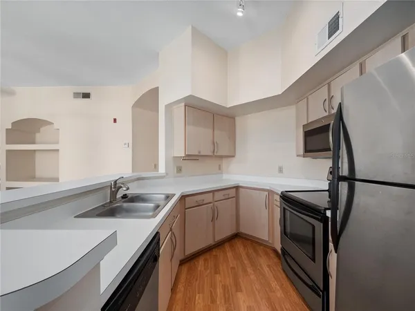 a kitchen with a sink appliances and cabinets