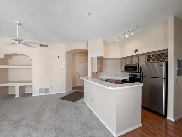 a kitchen with a sink a refrigerator and cabinets