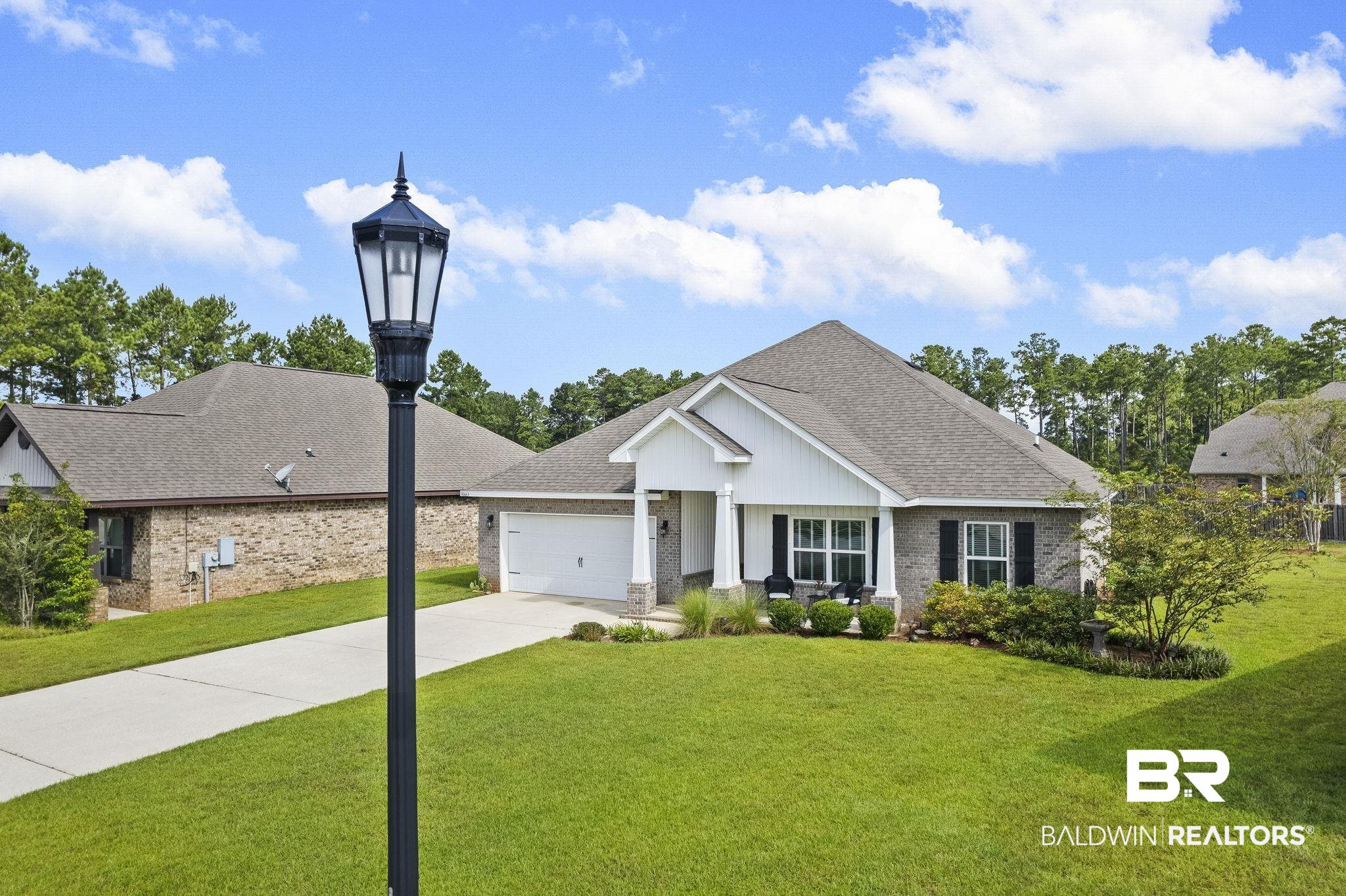 31663 Kestrel Loop Daphne, AL 36527 - Photo 64 of 86 View of front facade featuring a garage and a front lawn