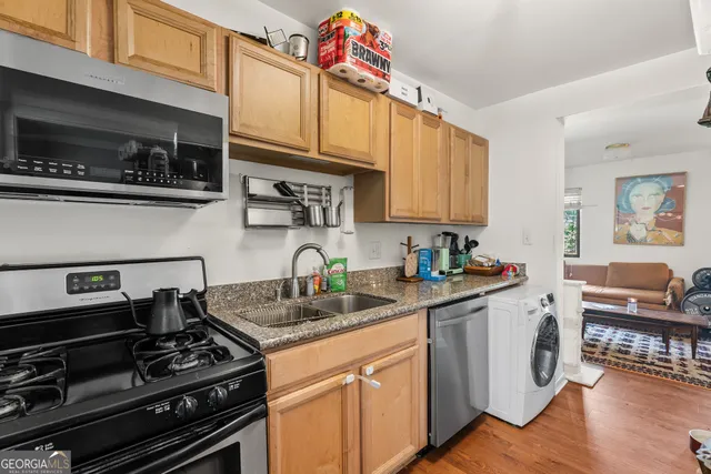 a kitchen with stainless steel appliances granite countertop a stove and a microwave
