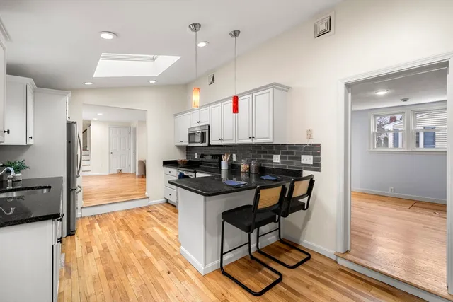 a kitchen with stainless steel appliances granite countertop a refrigerator and a sink