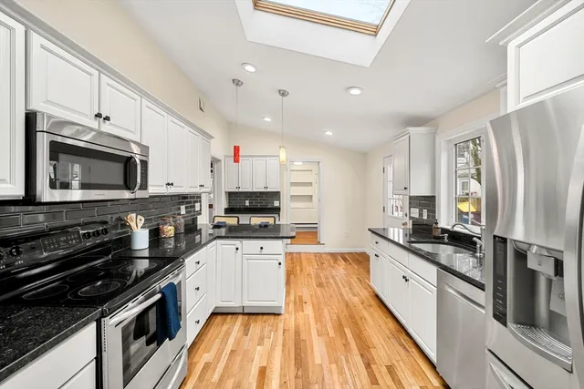a kitchen with wooden cabinets and a stove top oven