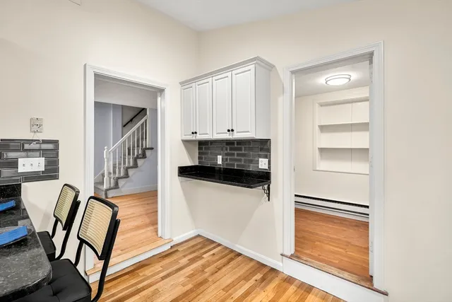 a view of empty room with wooden floor and window