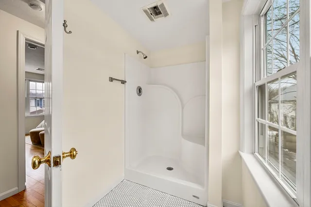 a bathroom with a granite countertop sink mirror vanity and toilet