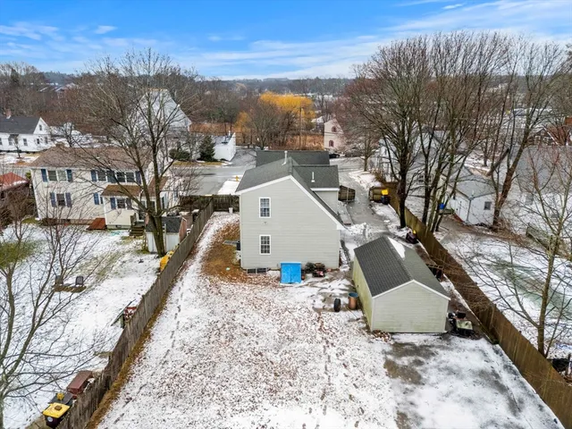a living room with furniture a rug a lamp and a large window