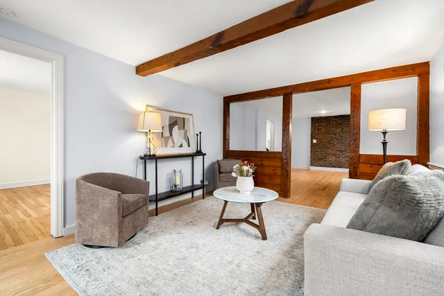 a living room with furniture and a lamp