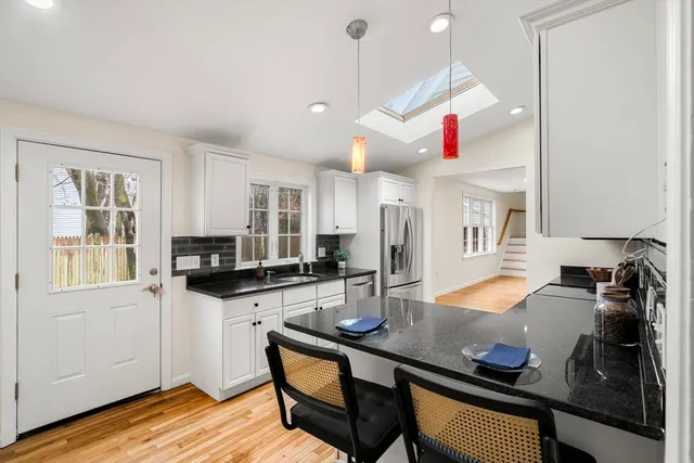 a kitchen with stainless steel appliances a stove a sink dishwasher and a refrigerator