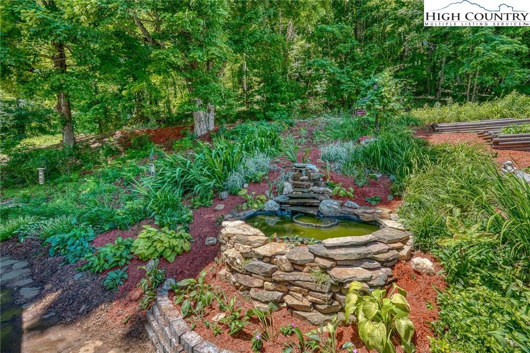363 Misty Mountain Road Boone, NC 28607 - Photo 13 of 50 a view of a lake with a house in the background