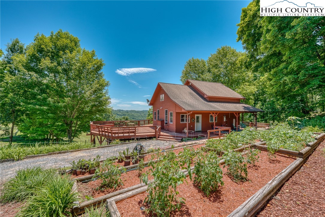 363 Misty Mountain Road Boone, NC 28607 - Photo 16 of 50 aerial view of a house with a big yard and potted plants