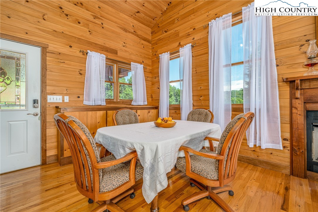363 Misty Mountain Road Boone, NC 28607 - Photo 21 of 50 a view of a dining room with furniture a chandelier and wooden floor