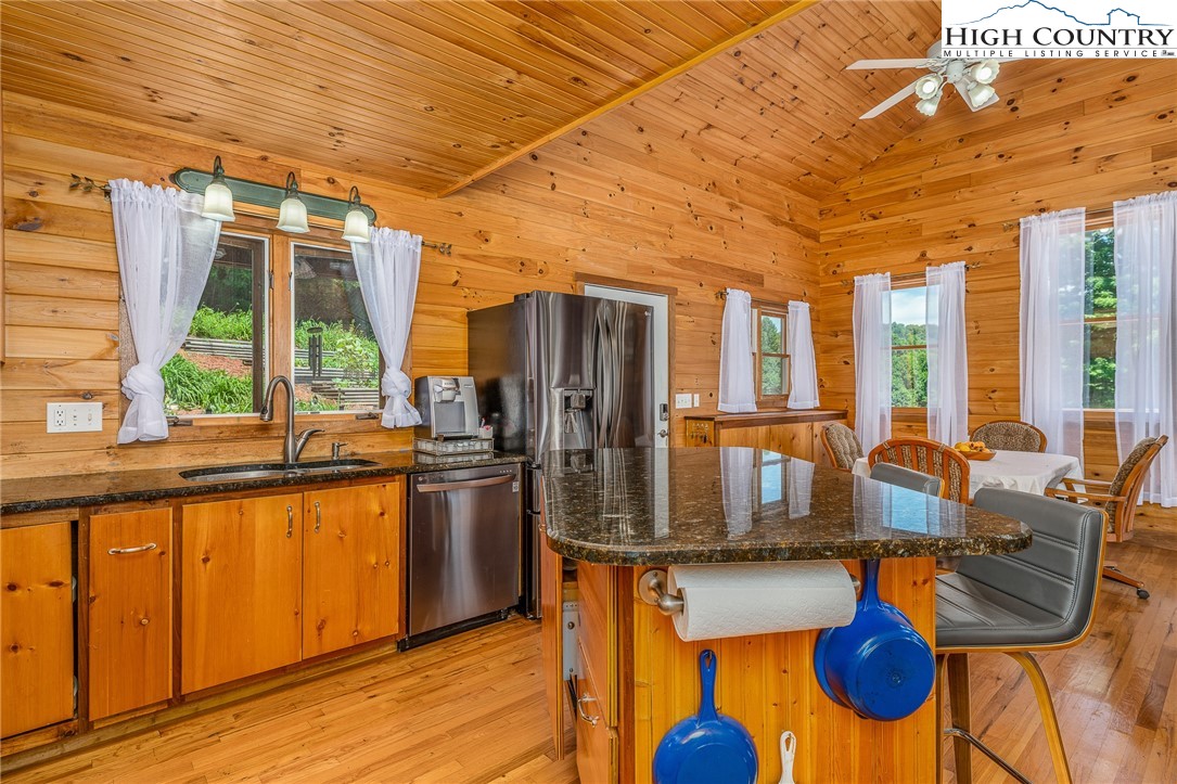 363 Misty Mountain Road Boone, NC 28607 - Photo 24 of 50 a kitchen with stainless steel appliances granite countertop a stove and refrigerator