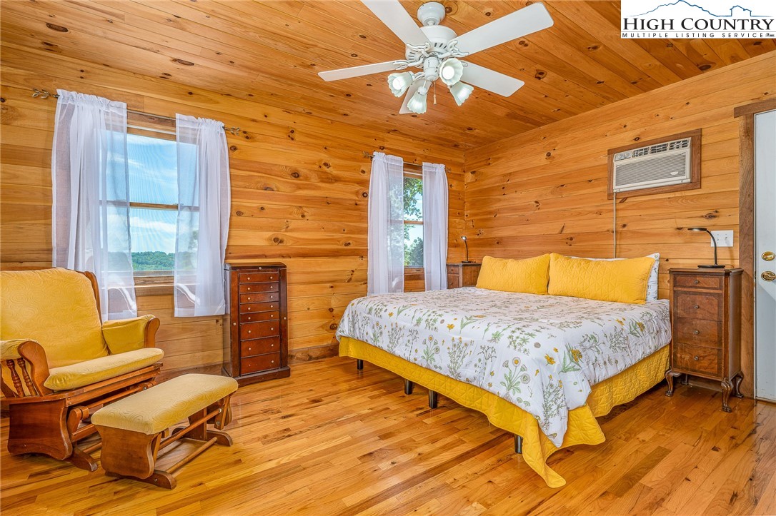363 Misty Mountain Road Boone, NC 28607 - Photo 26 of 50 a bedroom with a bed and wooden floor