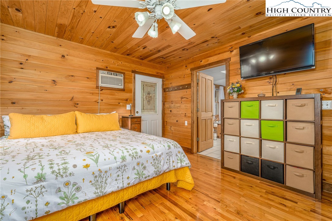 363 Misty Mountain Road Boone, NC 28607 - Photo 28 of 50 a bedroom with a bed and a flat screen tv