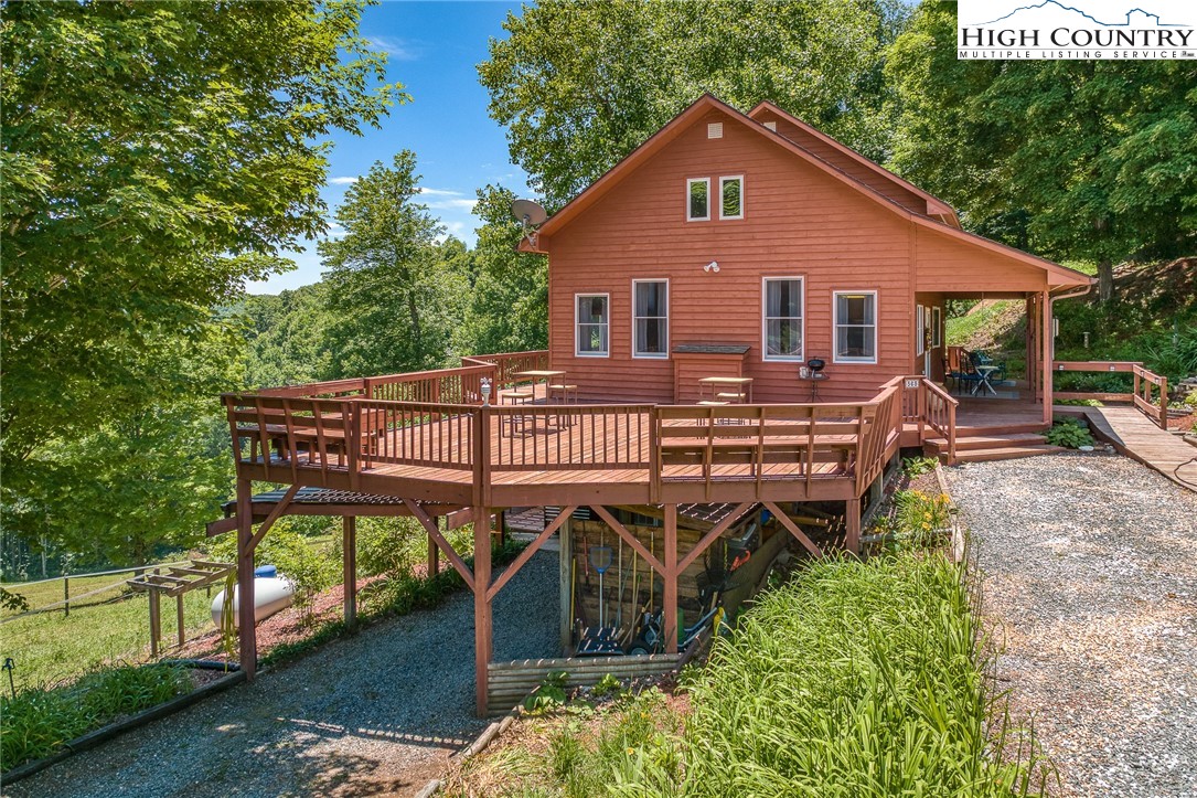363 Misty Mountain Road Boone, NC 28607 - Photo 3 of 50 a view of a house with wooden deck front of house
