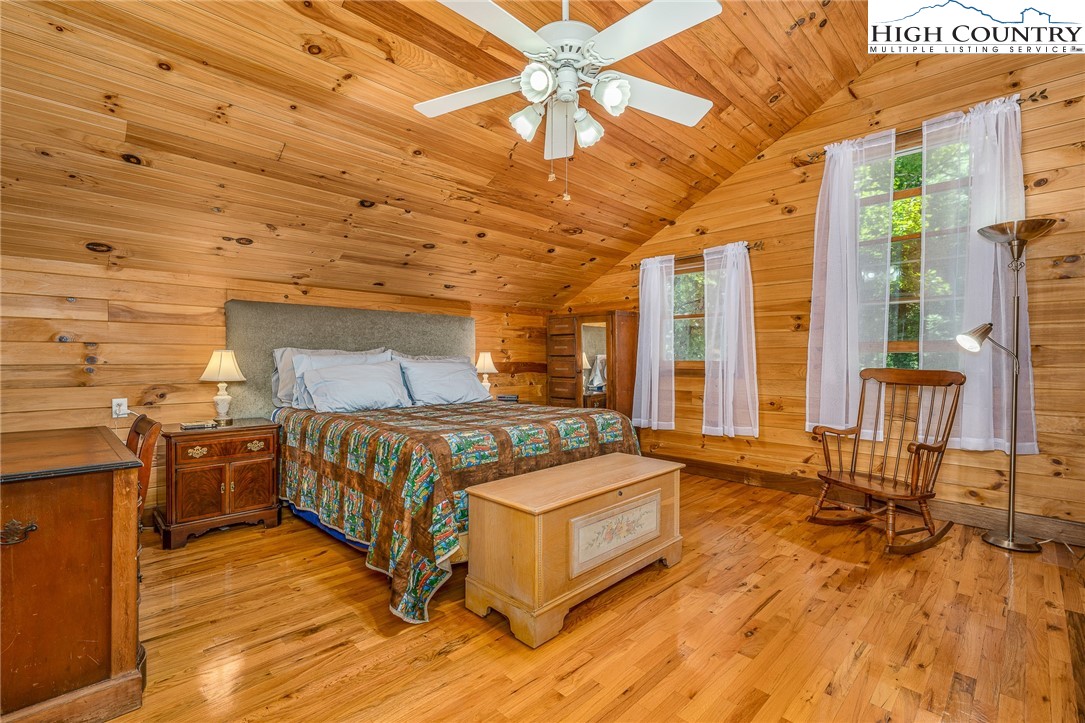 363 Misty Mountain Road Boone, NC 28607 - Photo 33 of 50 a spacious bedroom with a bed and large windows