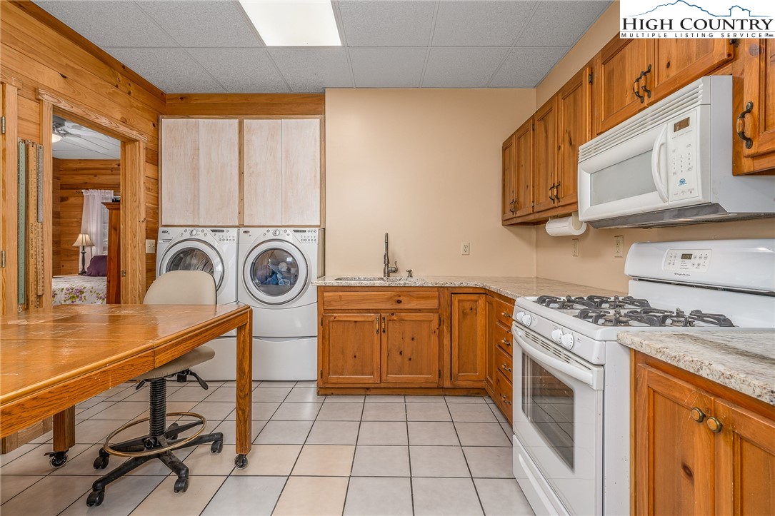 363 Misty Mountain Road Boone, NC 28607 - Photo 45 of 50 a kitchen with a stove a sink and a microwave
