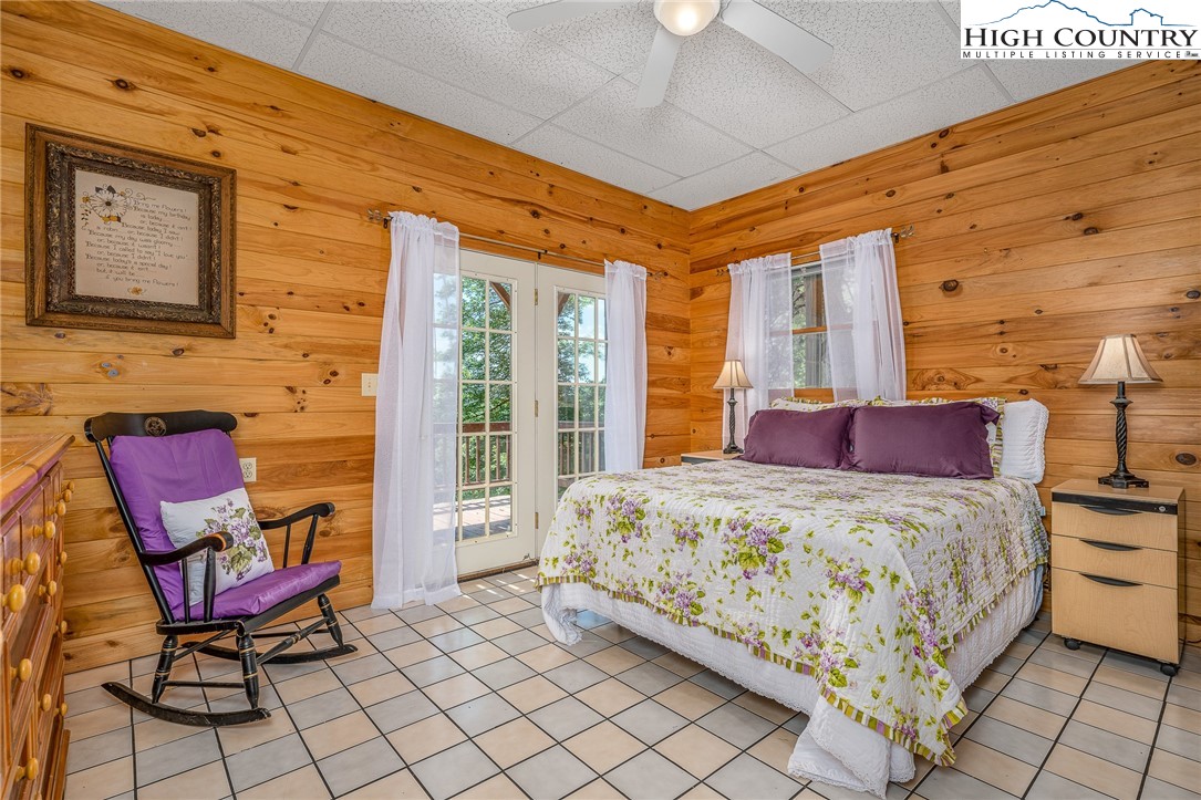 363 Misty Mountain Road Boone, NC 28607 - Photo 47 of 50 a bedroom with a bed and a lounge chair