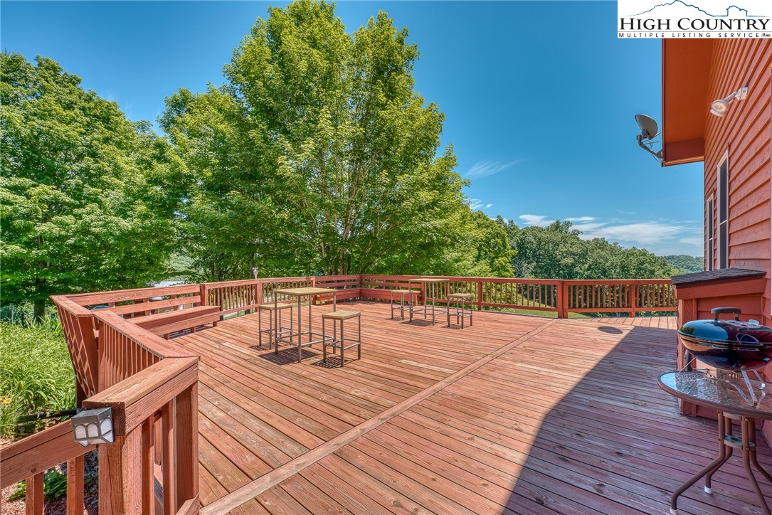 363 Misty Mountain Road Boone, NC 28607 - Photo 8 of 50 a balcony with wooden floor and outdoor seating