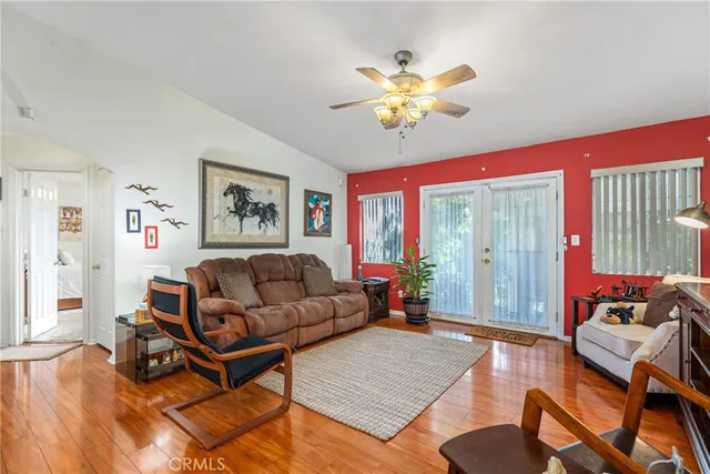 a living room with furniture and wooden floor