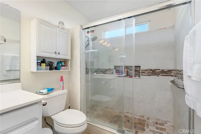 a bathroom with a shower a toilet and a sink