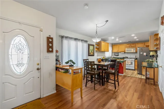 a view of a a dining room with furniture window and wooden floor