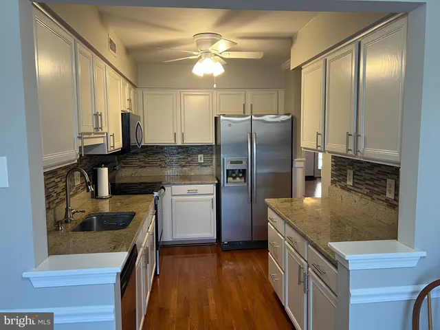 a kitchen with a refrigerator sink and stove