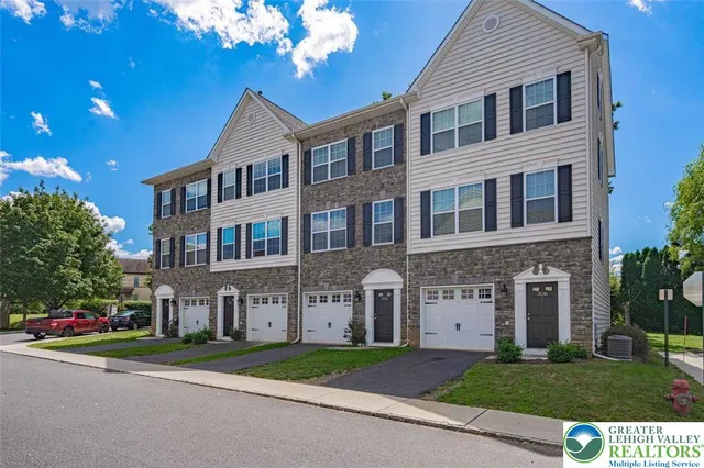 a brick building with a yard in front of it