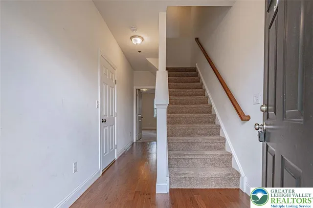 a view of entryway and gallery with wooden floor