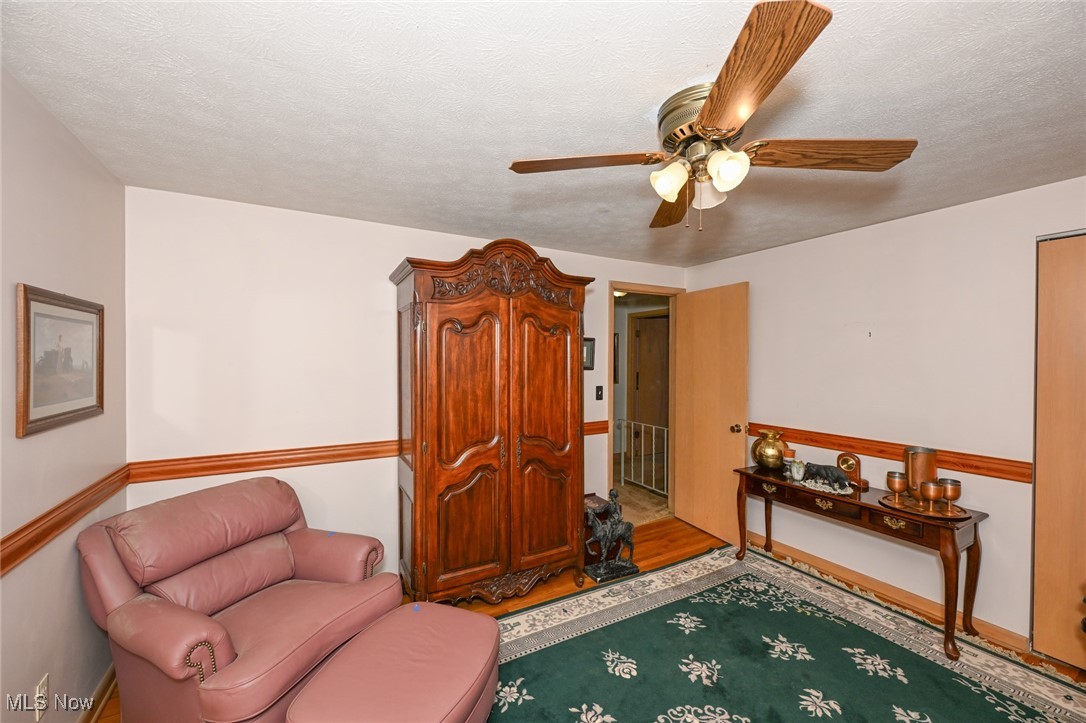30875 Cannon Road Solon, OH 44139 - Photo 35 of 48 Bedroom/Sitting room with a ceiling fan, a textured ceiling, and wood floors