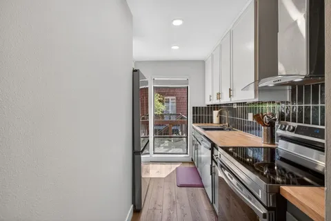 a kitchen with stainless steel appliances granite countertop a stove and a sink