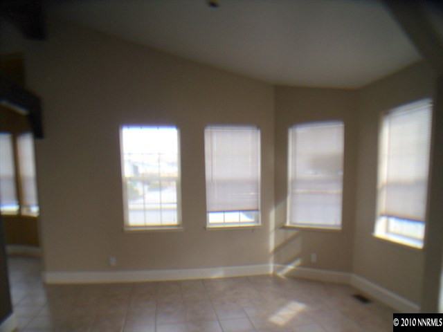 1258 Leopard Street Reno, NV 89506 - Photo 6 of 9 a view of an empty room with wooden floor and windows