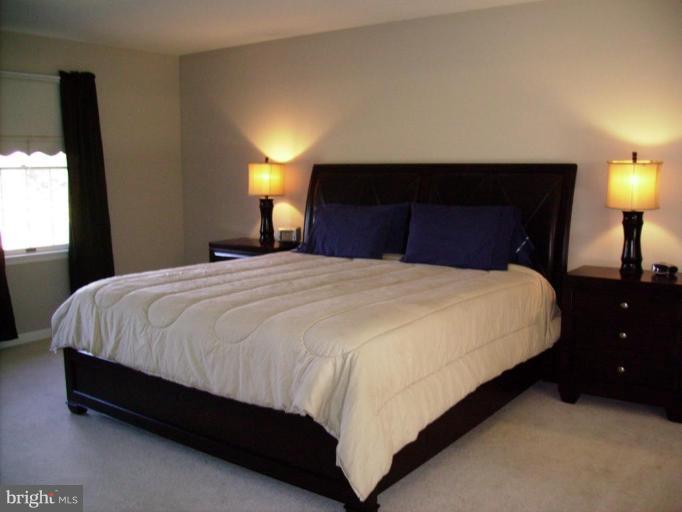 3105 Fallston Road Fallston, MD 21047 - Photo 15 of 30 a large bed sitting in a bedroom next to a lamp