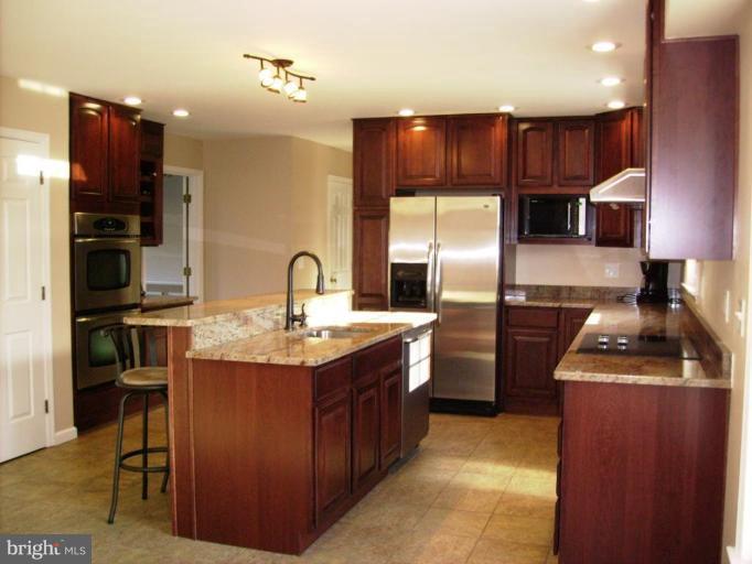 3105 Fallston Road Fallston, MD 21047 - Photo 6 of 30 a kitchen with stainless steel appliances granite countertop a refrigerator a stove and a sink