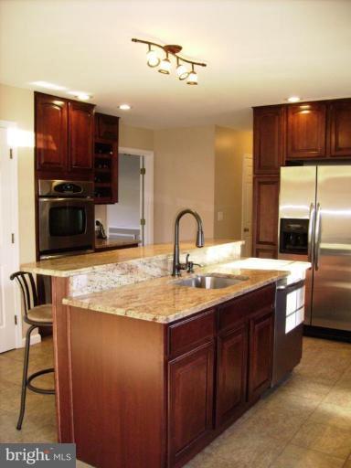 3105 Fallston Road Fallston, MD 21047 - Photo 7 of 30 a kitchen with stainless steel appliances granite countertop a sink a stove and a microwave