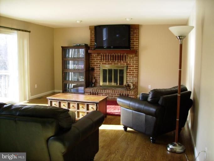 3105 Fallston Road Fallston, MD 21047 - Photo 9 of 30 a living room with furniture fireplace and flat screen tv