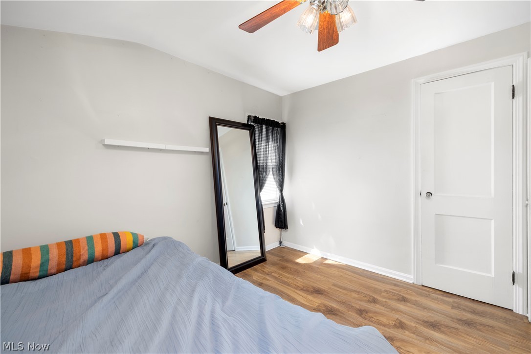 3305 Warren Road Cleveland, OH 44111 - Photo 7 of 28 Bedroom with vaulted ceiling, light hardwood / wood-style floors, and ceiling fan