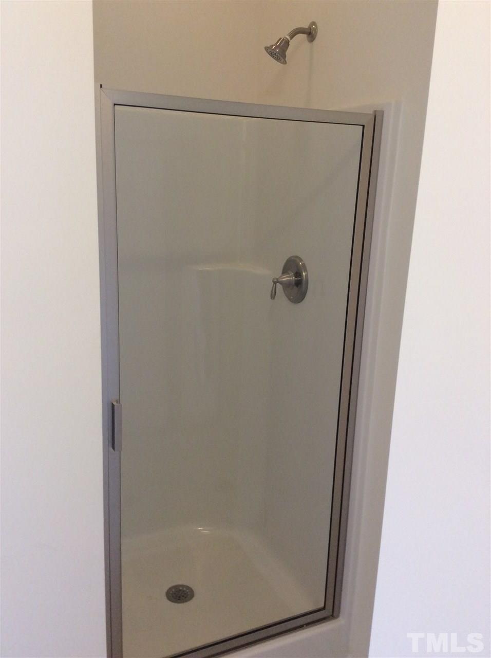 3633 Tule Spring Street Raleigh, NC 27610 - Photo 8 of 10 a bathroom with a glass shower door