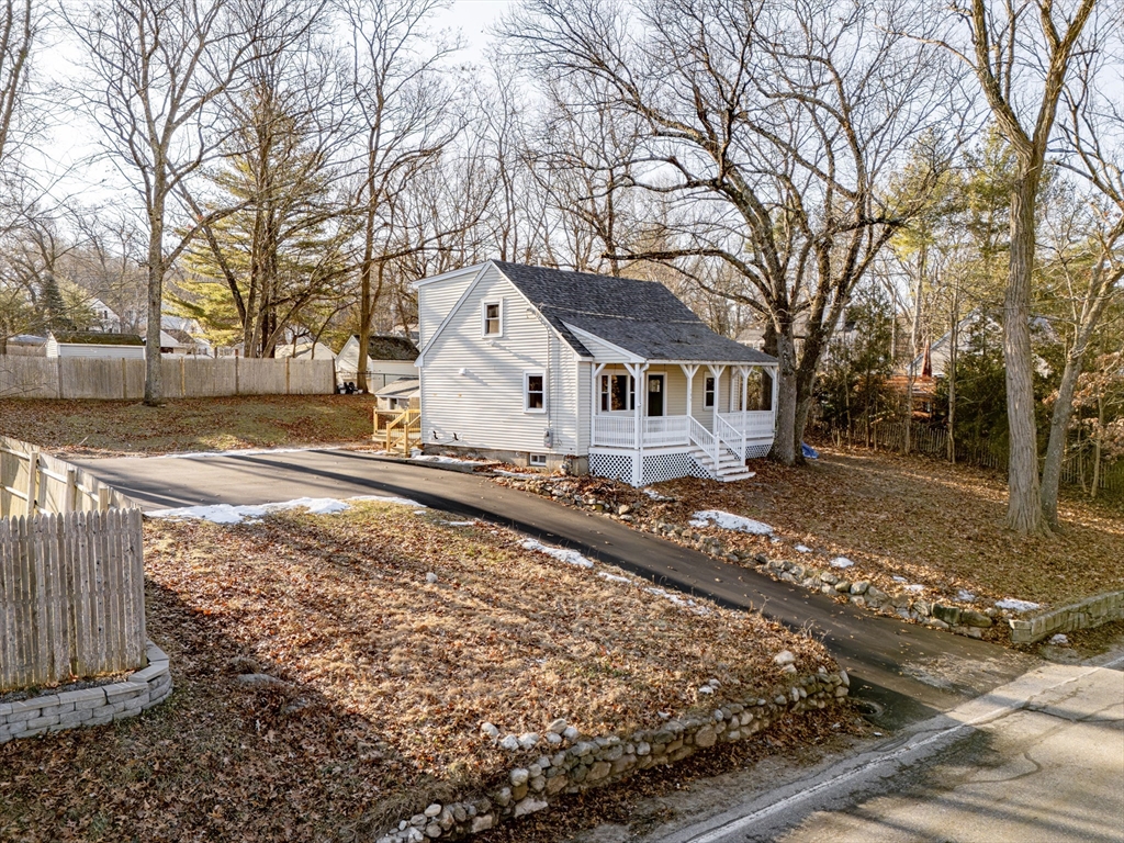 a view of a house with snow on the road