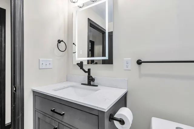 a bathroom with a sink vanity and a mirror