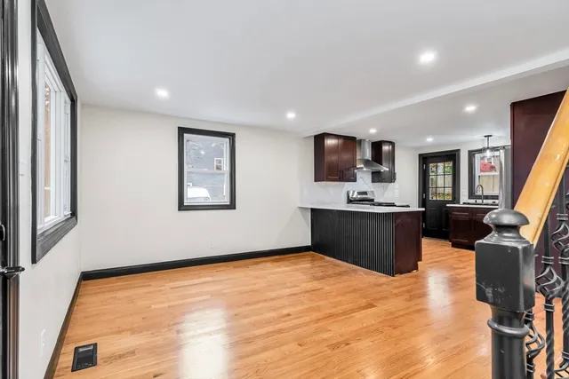 a view of kitchen with stainless steel appliances granite countertop sink stove and refrigerator