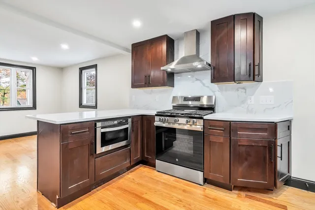 a kitchen with stainless steel appliances granite countertop a stove and a sink