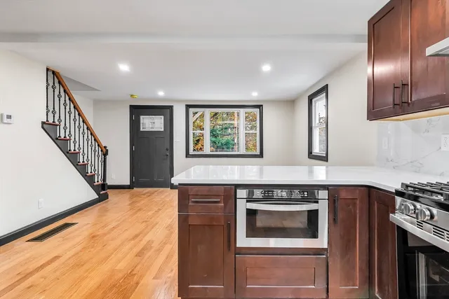 a kitchen with granite countertop a stove and a sink