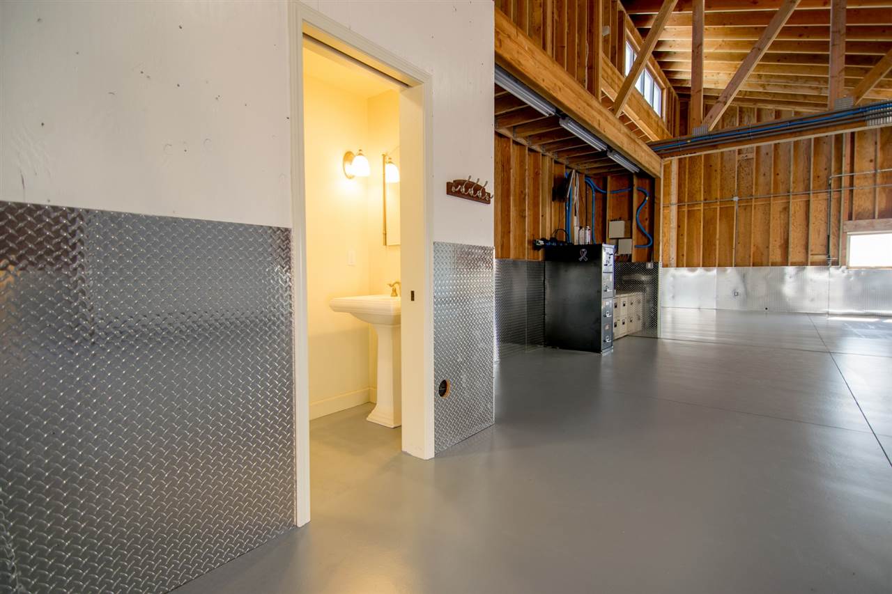 4605 Hana Highway Haiku, HI 96708 - Photo 28 of 30 a view of a hallway with wooden floor and staircase