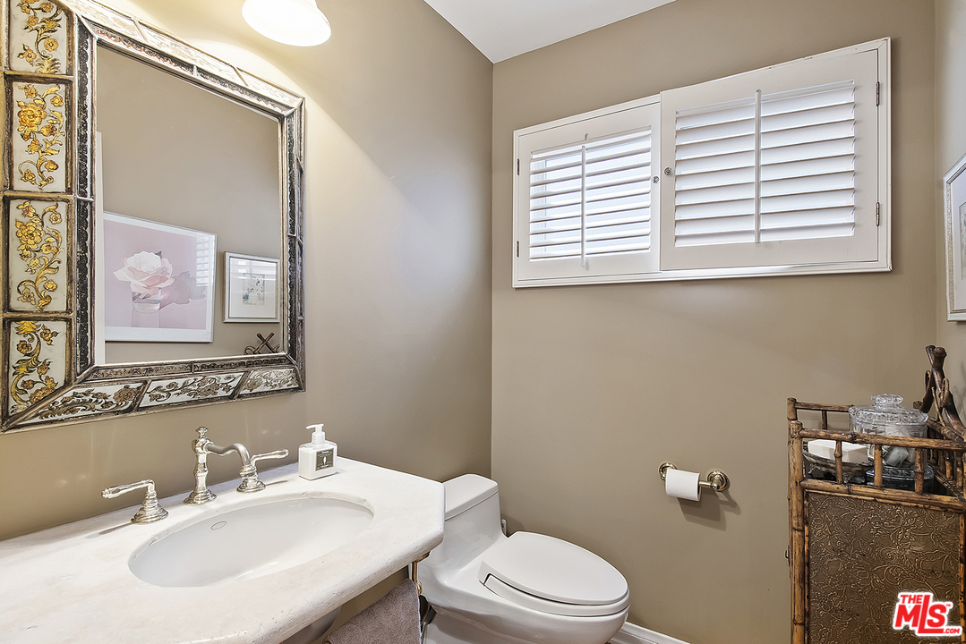 21 Westwind Street Marina del Rey, CA 90292 - Photo 37 of 52 a bathroom with a sink a mirror and a toilet