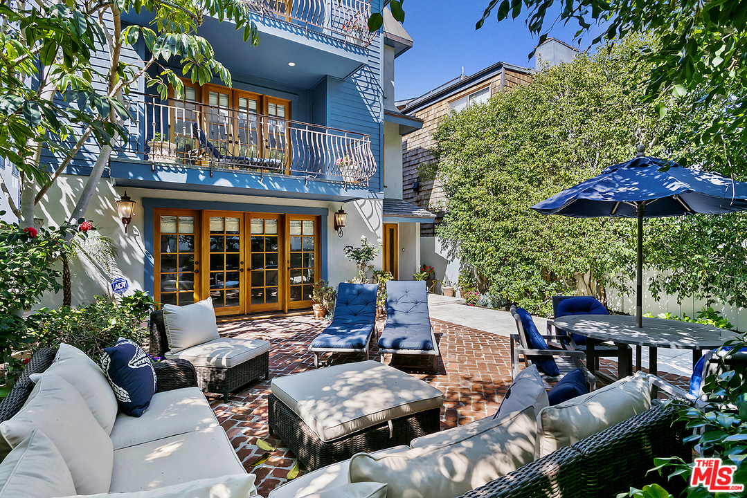 21 Westwind Street Marina del Rey, CA 90292 - Photo 5 of 52 a view of a patio with chairs and a table and chairs under an umbrella with a fire pit