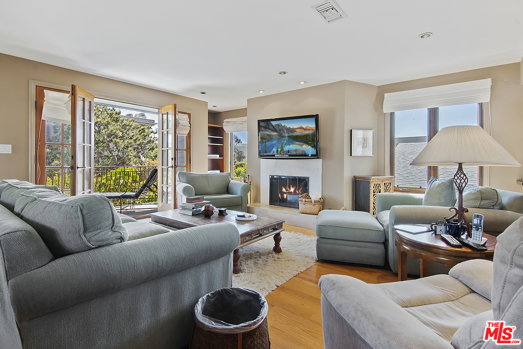 21 Westwind Street Marina del Rey, CA 90292 - Photo 49 of 52 a living room with furniture a large window and a fireplace