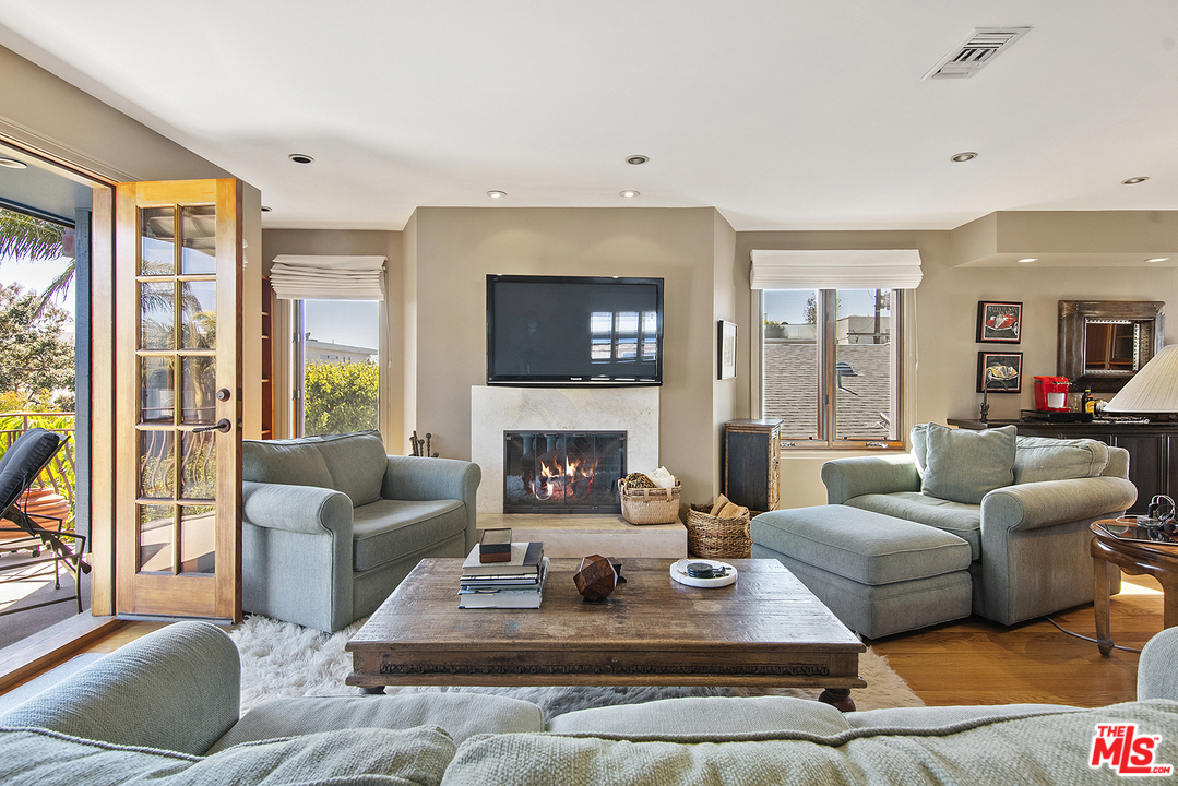 21 Westwind Street Marina del Rey, CA 90292 - Photo 50 of 52 a living room with fireplace furniture and a large window