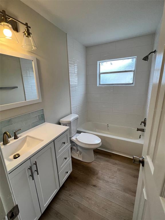 7224 Daggett Terrace New Port Richey, FL 34655 - Photo 11 of 14 a bathroom with a toilet sink and mirror